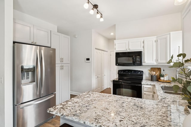 3453 Parkwood Ct, Hermitage, TN 37076 - kitchen with black appliances, light stone countertops, backsplash, a peninsula, and recessed lighting