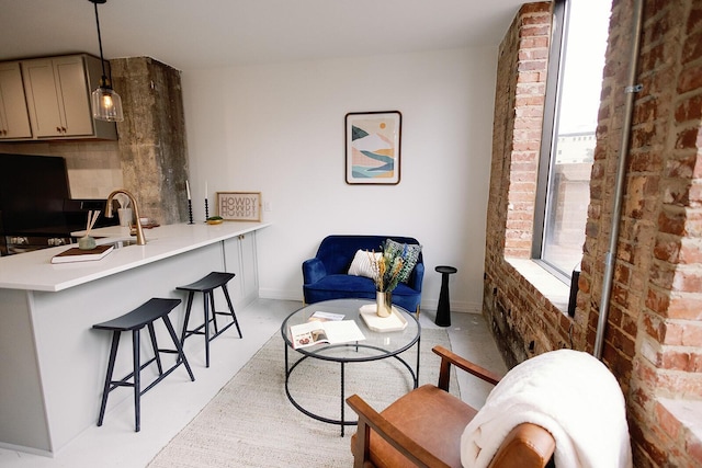 117 E 7th St Unit 202, Chattanooga, TN 37402 - living area with baseboards and brick wall