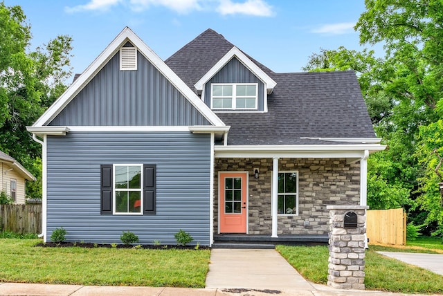 813 Central Ave, Hopkinsville, KY 42240 - view of front facade featuring board and batten siding, a shingled roof, covered porch, and stone siding