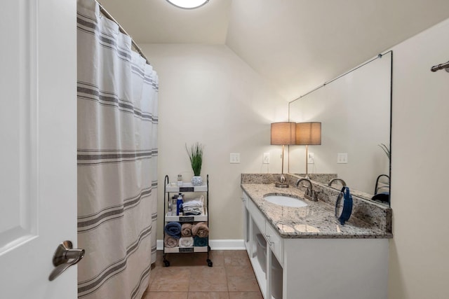 5950 Clarksville Pike, Joelton, TN 37080 - full bath with vanity, vaulted ceiling, baseboards, tile patterned floors, and curtained shower