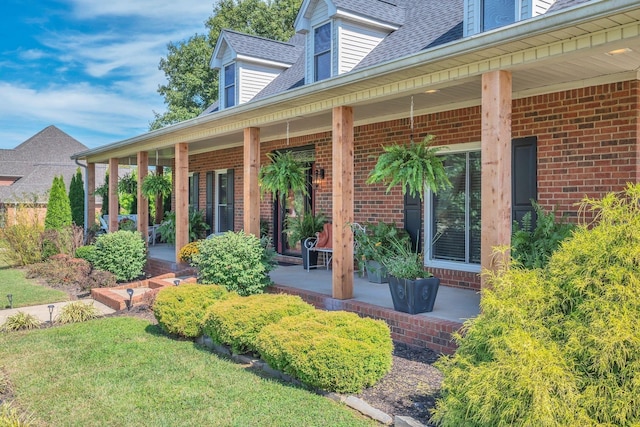 5950 Clarksville Pike, Joelton, TN 37080 - entrance to property with covered porch, brick siding, and roof with shingles