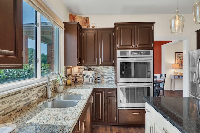 5950 Clarksville Pike, Joelton, TN 37080 - kitchen featuring stainless steel appliances, a sink, tasteful backsplash, light stone counters, and dark brown cabinets