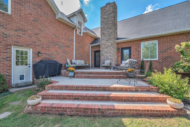 5950 Clarksville Pike, Joelton, TN 37080 - entrance to property featuring a chimney, a patio, brick siding, a shingled roof, and an outdoor living space