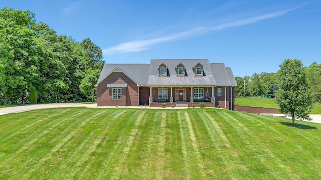 152 Camaro Dr, Chapmansboro, TN 37035 - cape cod home with a porch, a front yard, and brick siding