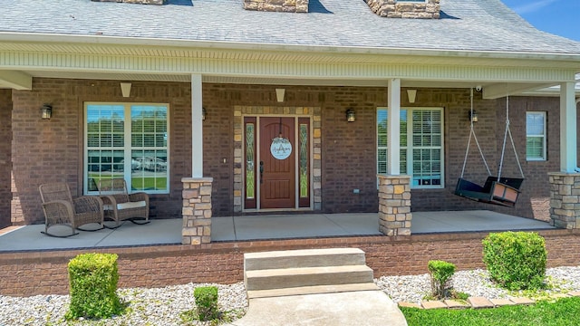 152 Camaro Dr, Chapmansboro, TN 37035 - doorway to property featuring a porch, brick siding, and a shingled roof