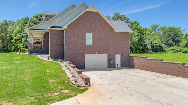 152 Camaro Dr, Chapmansboro, TN 37035 - view of property exterior with a yard, driveway, an attached garage, and brick siding