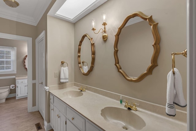 161 Graystone Dr, Gallatin, TN 37066 - bathroom featuring double vanity, toilet, a skylight, and ornamental molding