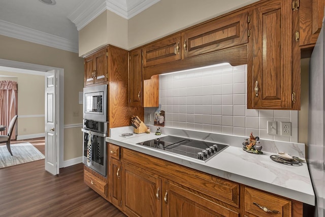 161 Graystone Dr, Gallatin, TN 37066 - kitchen with stainless steel appliances, crown molding, brown cabinets, light countertops, and backsplash