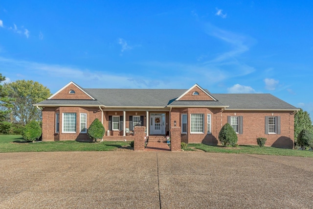 161 Graystone Dr, Gallatin, TN 37066 - view of front facade with brick siding, a porch, and a front lawn