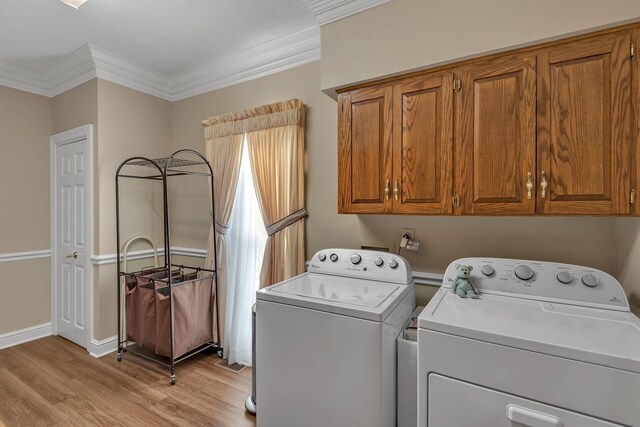 161 Graystone Dr, Gallatin, TN 37066 - washroom with washer and clothes dryer, light wood-style floors, cabinet space, ornamental molding, and baseboards