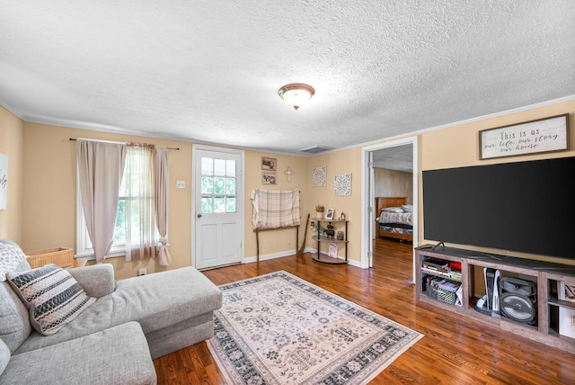 154 Crains Landing Rd, Dover, TN 37058 - living room with wood finished floors, a textured ceiling, baseboards, and crown molding
