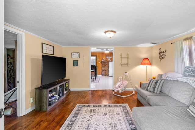 154 Crains Landing Rd, Dover, TN 37058 - living room with wood finished floors, ornamental molding, ceiling fan, baseboards, and a textured ceiling