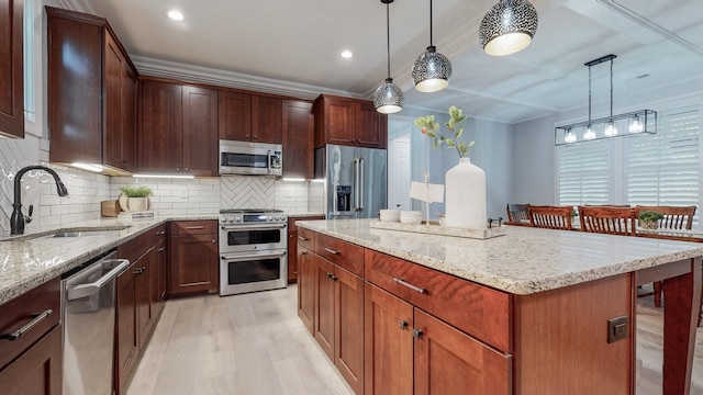 20 Daniels Dr, Franklin, TN 37064 - kitchen featuring appliances with stainless steel finishes, a sink, light wood-type flooring, light stone countertops, and decorative backsplash