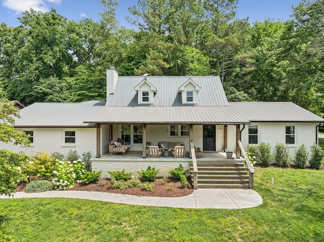 3348 Sweeney Hollow Rd, Franklin, TN 37064 - view of front of property with a chimney, a front lawn, brick siding, a metal roof, and covered porch