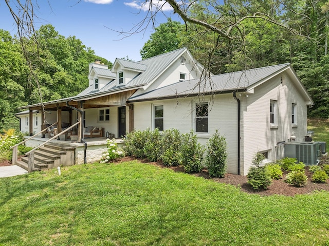 3348 Sweeney Hollow Rd, Franklin, TN 37064 - view of front facade featuring a front lawn, brick siding, a metal roof, and a chimney
