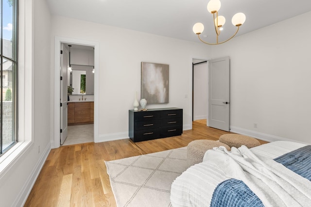 2915 Compton Rd, Nashville, TN 37215 - bedroom with light wood-style floors, a chandelier, baseboards, and connected bathroom