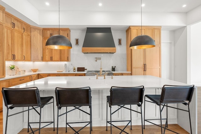 2915 Compton Rd, Nashville, TN 37215 - kitchen featuring custom range hood, light countertops, tasteful backsplash, a large island with sink, and hanging light fixtures