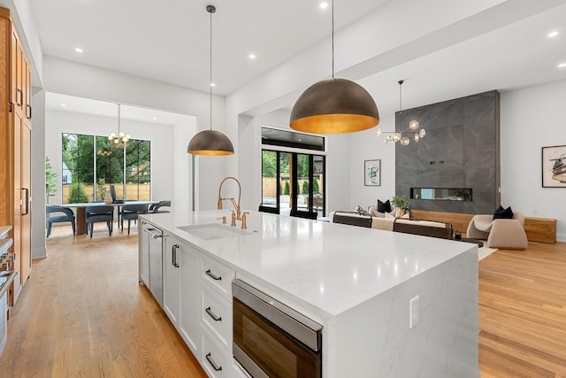 2915 Compton Rd, Nashville, TN 37215 - kitchen with a sink, stainless steel microwave, a chandelier, light wood-style flooring, and recessed lighting