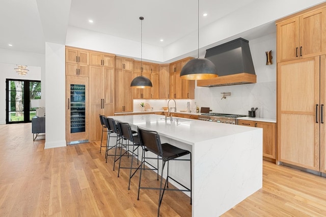 2915 Compton Rd, Nashville, TN 37215 - kitchen with custom range hood, wine cooler, light wood-style floors, a kitchen bar, and recessed lighting