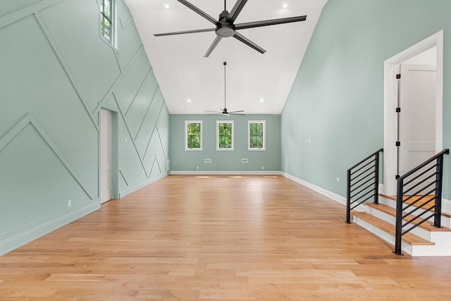 2915 Compton Rd, Nashville, TN 37215 - unfurnished living room with a ceiling fan, high vaulted ceiling, light wood-style flooring, baseboards, and stairs