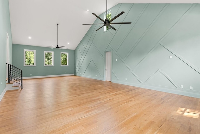 2915 Compton Rd, Nashville, TN 37215 - unfurnished living room featuring a decorative wall, ceiling fan, stairs, light wood-style flooring, and lofted ceiling
