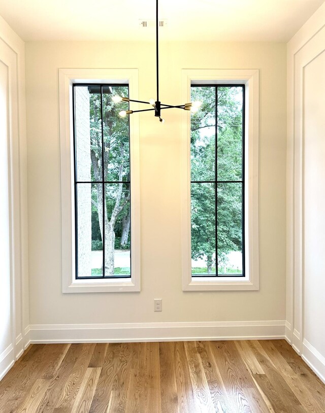 2915 Compton Rd, Nashville, TN 37215 - unfurnished dining area with a chandelier, wood finished floors, and baseboards