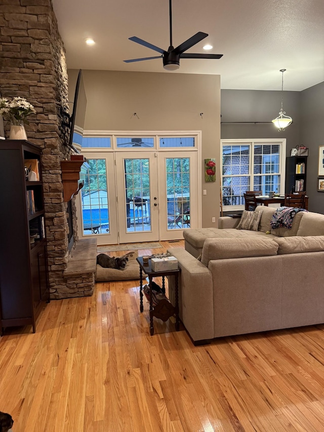 31 Chickory Ln, Monteagle, TN 37356 - living room with hardwood / wood-style floors, a ceiling fan, and a stone fireplace