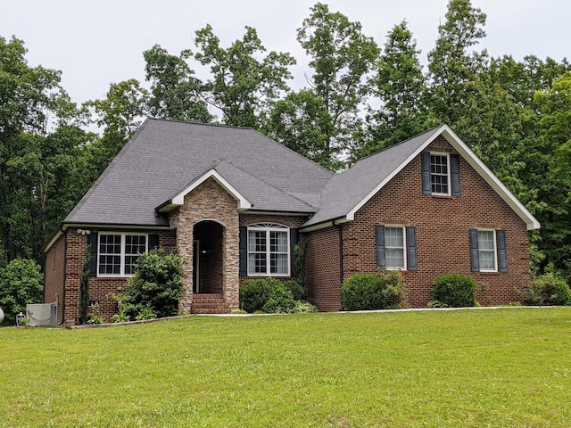 31 Chickory Ln, Monteagle, TN 37356 - view of front facade featuring brick siding, a front lawn, cooling unit, and a shingled roof