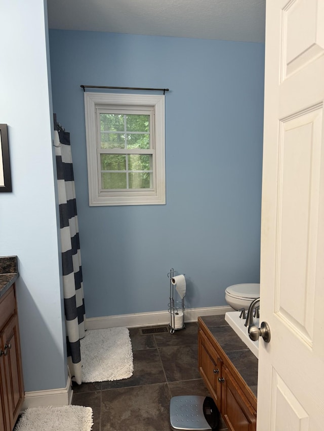 31 Chickory Ln, Monteagle, TN 37356 - bathroom with vanity, baseboards, curtained shower, and toilet