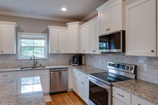 2001 Katach Ct, Spring Hill, TN 37174 - kitchen featuring stainless steel appliances, white cabinets, backsplash, crown molding, and recessed lighting