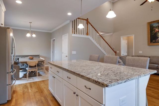 2001 Katach Ct, Spring Hill, TN 37174 - kitchen featuring freestanding refrigerator, light wood finished floors, light stone countertops, ornamental molding, and recessed lighting