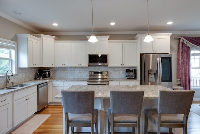 2001 Katach Ct, Spring Hill, TN 37174 - kitchen featuring stainless steel appliances, white cabinetry, plenty of natural light, crown molding, and recessed lighting