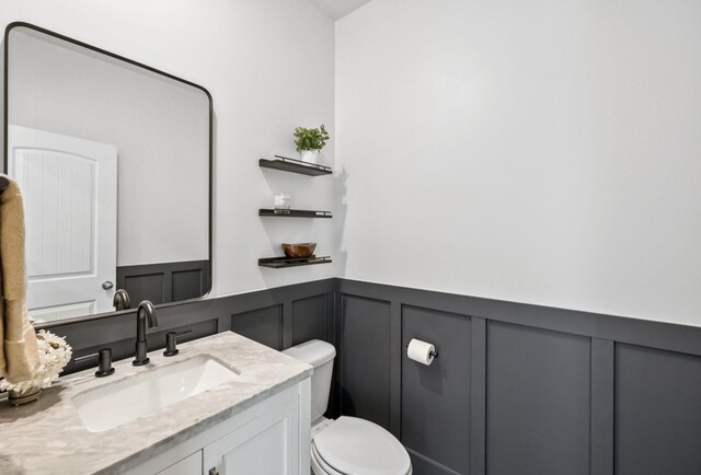 1013 Pepper Stone Dr, Lebanon, TN 37087 - half bathroom featuring a decorative wall, vanity, and a wainscoted wall