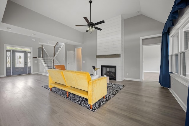 276 Indian Creek Rd, Cumberland Furnace, TN 37051 - living area featuring ceiling fan, stairway, wood finished floors, a fireplace, and high vaulted ceiling