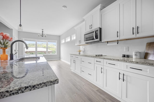 276 Indian Creek Rd, Cumberland Furnace, TN 37051 - kitchen with stainless steel microwave, a sink, tasteful backsplash, and light wood-style flooring