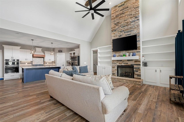 6400 Williams Rd, Cross Plains, TN 37049 - living area featuring a ceiling fan, high vaulted ceiling, dark wood-style floors, a stone fireplace, and recessed lighting
