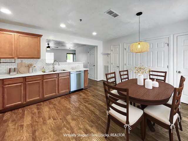 4017 Pavati Trce, Spring Hill, TN 37174 - kitchen with dishwasher, a sink, a peninsula, brown cabinets, and dark wood-type flooring