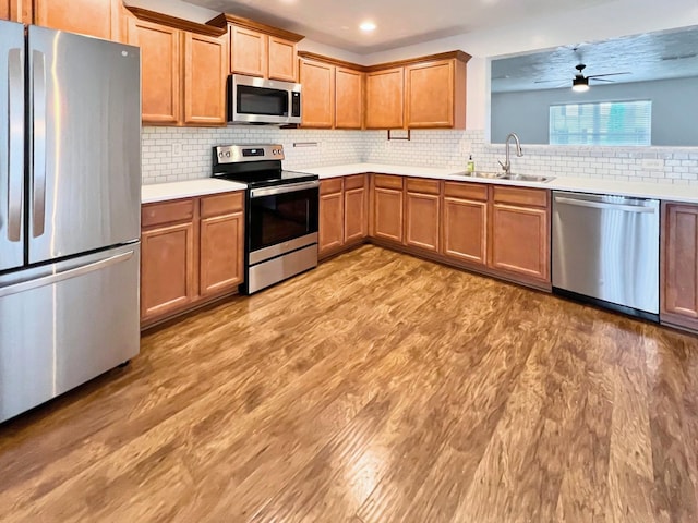 4017 Pavati Trce, Spring Hill, TN 37174 - kitchen with stainless steel appliances, a sink, ceiling fan, light countertops, and light wood-style flooring