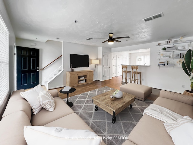 4017 Pavati Trce, Spring Hill, TN 37174 - living room with ceiling fan, stairs, baseboards, wood finished floors, and plenty of natural light
