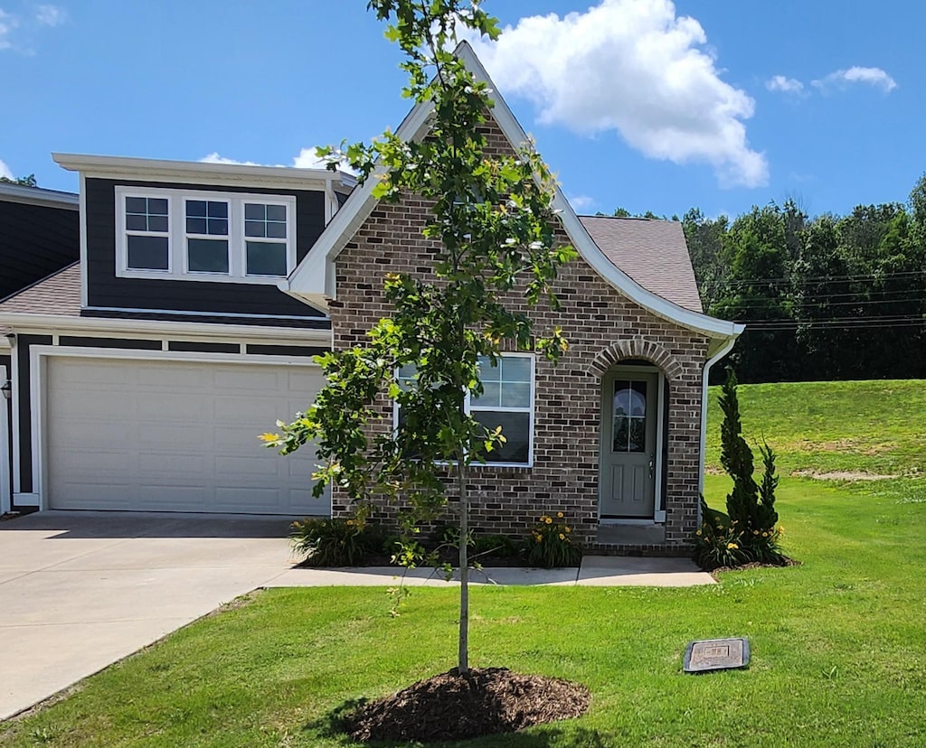 465 Multrees Pl, Smyrna, TN 37167 - view of front facade with driveway, brick siding, a front lawn, and an attached garage