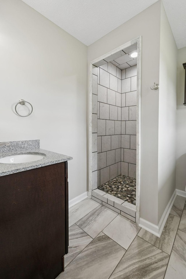 2762 Hunters Point Pike, Lebanon, TN 37087 - bathroom featuring marble look tiles, a tile shower, and vanity