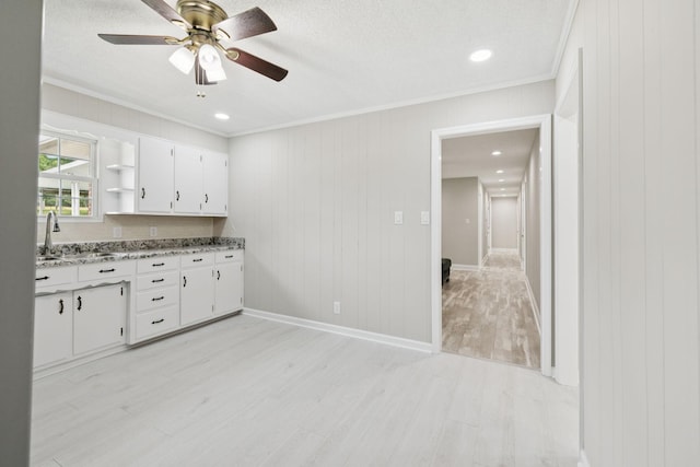 2762 Hunters Point Pike, Lebanon, TN 37087 - kitchen featuring crown molding, open shelves, light wood-style flooring, white cabinets, and a ceiling fan