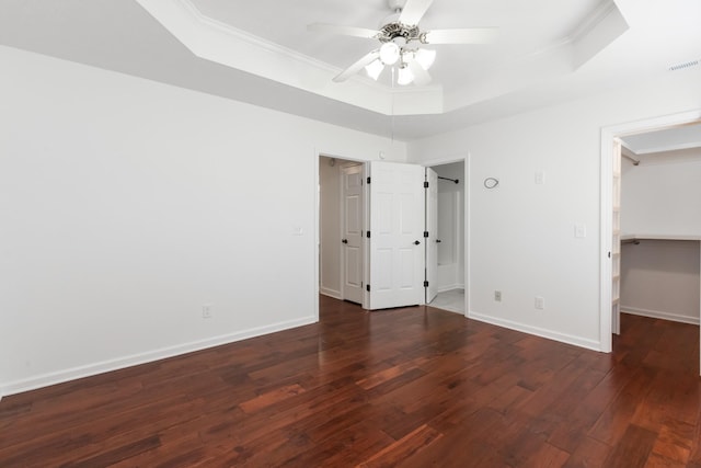 5026 Hectare Ln, La Vergne, TN 37086 - unfurnished bedroom with a raised ceiling, crown molding, wood finished floors, a walk in closet, and baseboards