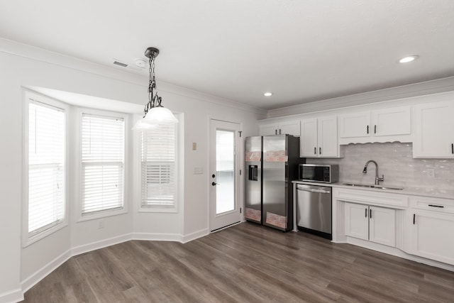 5026 Hectare Ln, La Vergne, TN 37086 - kitchen with stainless steel appliances, a sink, crown molding, dark wood-style flooring, and light countertops