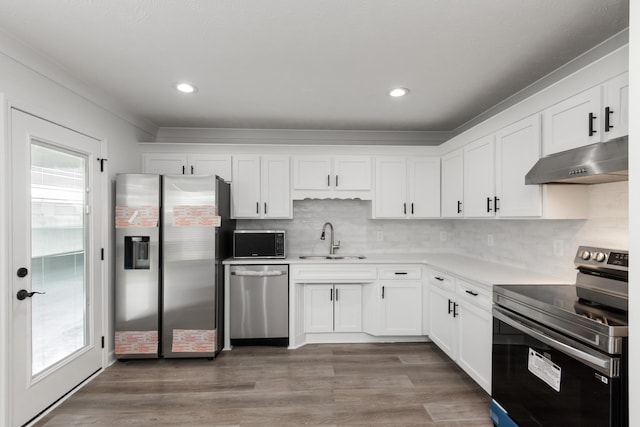 5026 Hectare Ln, La Vergne, TN 37086 - kitchen with appliances with stainless steel finishes, under cabinet range hood, a sink, white cabinets, and crown molding
