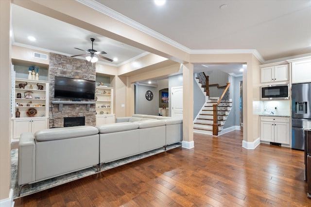 793 Alameda Ave, Nolensville, TN 37135 - living room with ceiling fan, dark wood finished floors, a fireplace, ornamental molding, and stairway