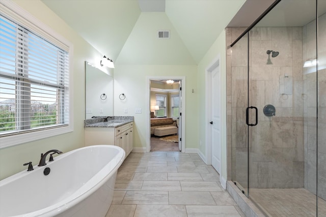 793 Alameda Ave, Nolensville, TN 37135 - bathroom with a soaking tub, vanity, a shower stall, vaulted ceiling, and baseboards