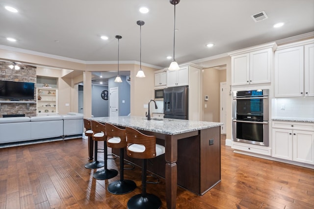 793 Alameda Ave, Nolensville, TN 37135 - kitchen featuring stainless steel appliances, dark wood-style flooring, crown molding, a sink, and white cabinetry