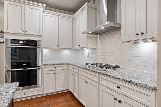 793 Alameda Ave, Nolensville, TN 37135 - kitchen featuring stainless steel appliances, wall chimney range hood, dark wood-style floors, backsplash, and light stone countertops