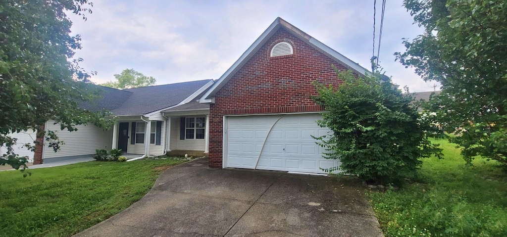1063 Stonemark Trl, La Vergne, TN 37086 - view of front of house featuring driveway, a garage, a front lawn, and brick siding